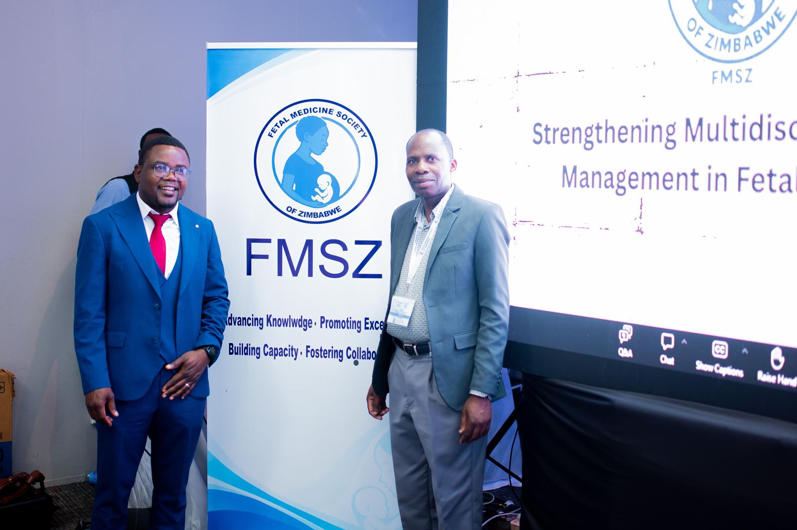 Clinicians at the Annual Congress, standing beside the congress banner